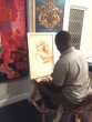 Talented artist Allan Pachino Wallace working on a painting at The Art Room.